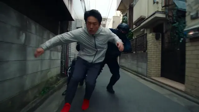 Man running through a narrow city alley